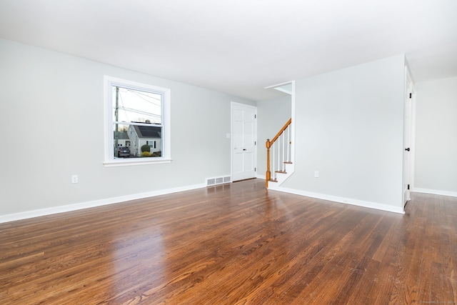 empty room with dark hardwood / wood-style floors