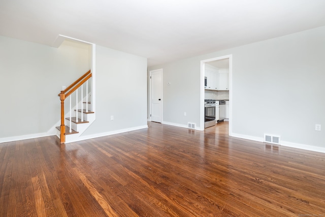 unfurnished living room with dark hardwood / wood-style flooring