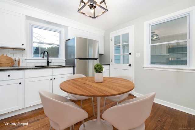 dining room with dark hardwood / wood-style flooring and sink