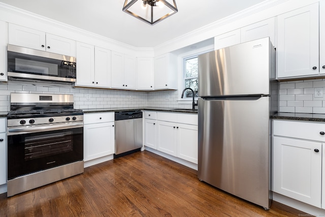 kitchen featuring sink, white cabinetry, dark wood-type flooring, and appliances with stainless steel finishes