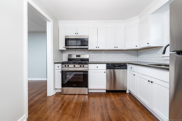 kitchen with dark hardwood / wood-style floors, white cabinetry, and stainless steel appliances