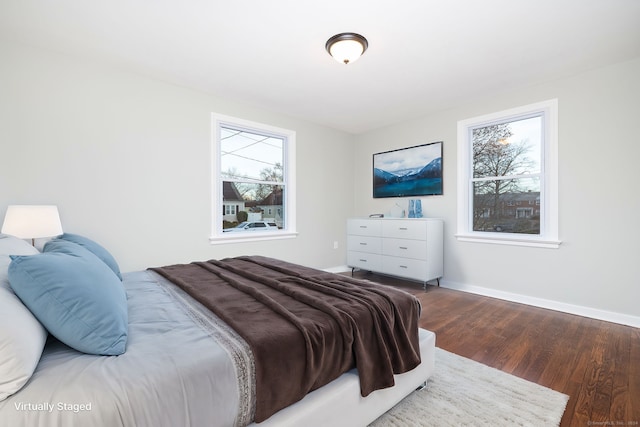 bedroom featuring dark hardwood / wood-style flooring and multiple windows