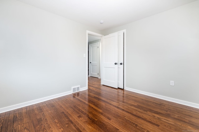 unfurnished room featuring dark hardwood / wood-style flooring