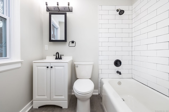 full bathroom with hardwood / wood-style floors, vanity, toilet, and tiled shower / bath