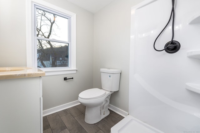 bathroom with sink, toilet, and hardwood / wood-style flooring