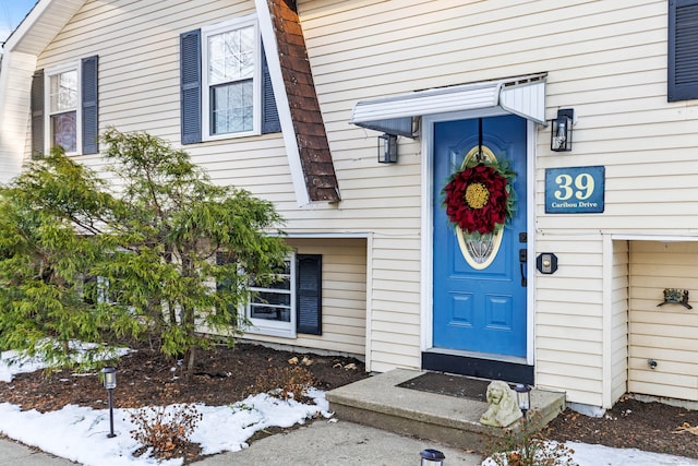 view of snow covered property entrance