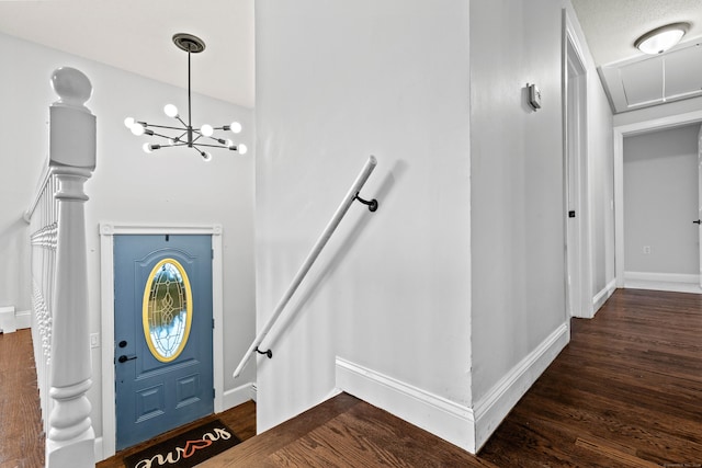 entrance foyer with dark hardwood / wood-style floors and a chandelier