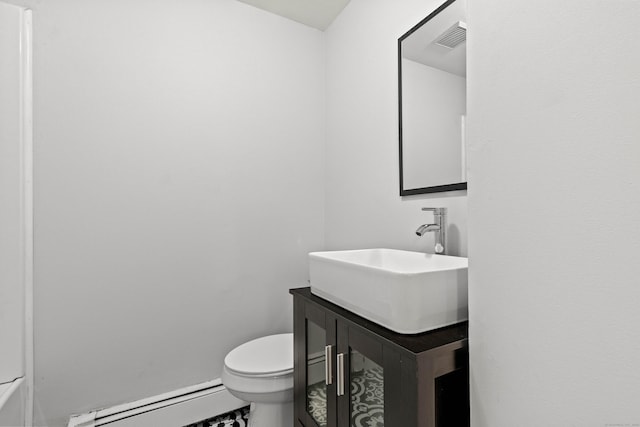 bathroom featuring vanity, toilet, and a baseboard heating unit