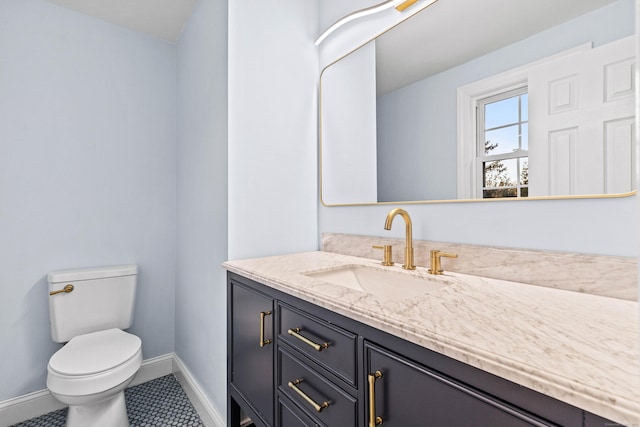 bathroom featuring tile patterned floors, vanity, and toilet