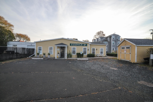 view of front of house featuring a storage shed