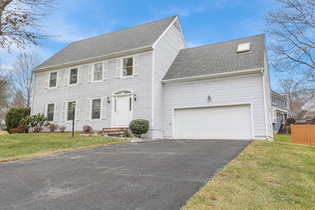 colonial-style house with a front lawn and a garage