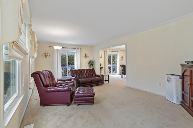 carpeted living room with a wealth of natural light and ornamental molding