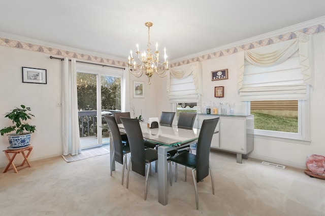 carpeted dining space with plenty of natural light, crown molding, and an inviting chandelier