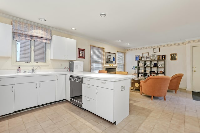 kitchen featuring kitchen peninsula, ornamental molding, sink, white cabinets, and black dishwasher