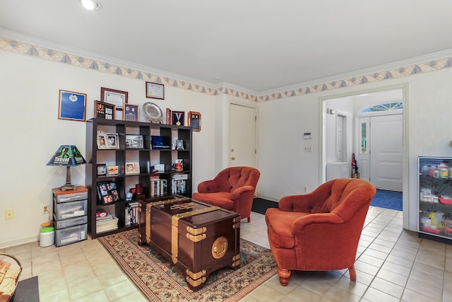 sitting room with crown molding and tile patterned flooring