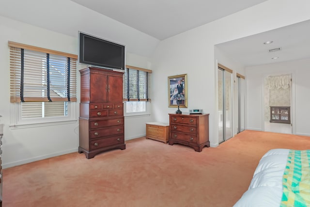 carpeted bedroom with vaulted ceiling