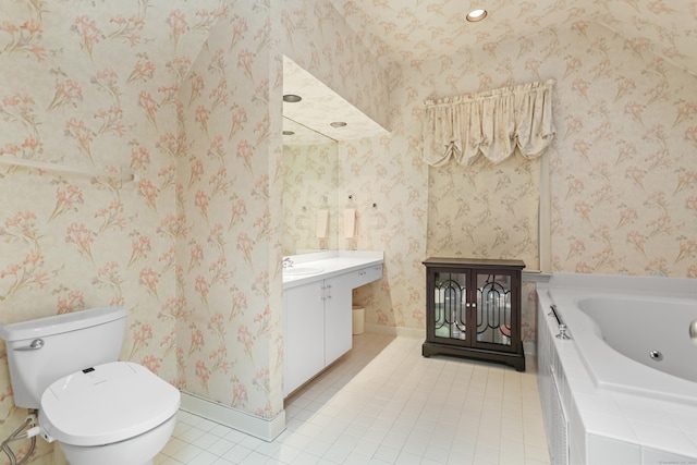 bathroom featuring tile patterned floors, a bathtub, vanity, and toilet