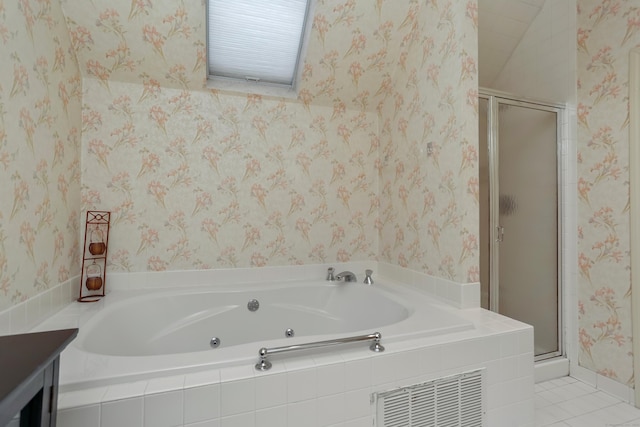 bathroom featuring plus walk in shower, vanity, and tile patterned flooring