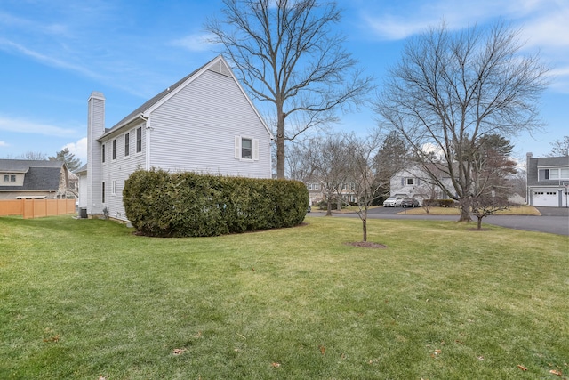 view of side of home with a yard