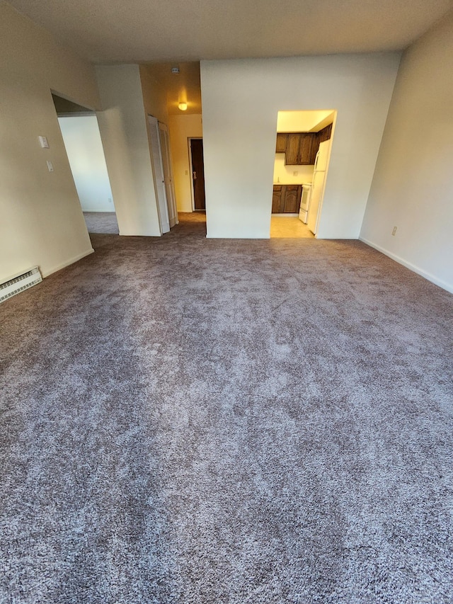 unfurnished living room with a baseboard heating unit and carpet floors