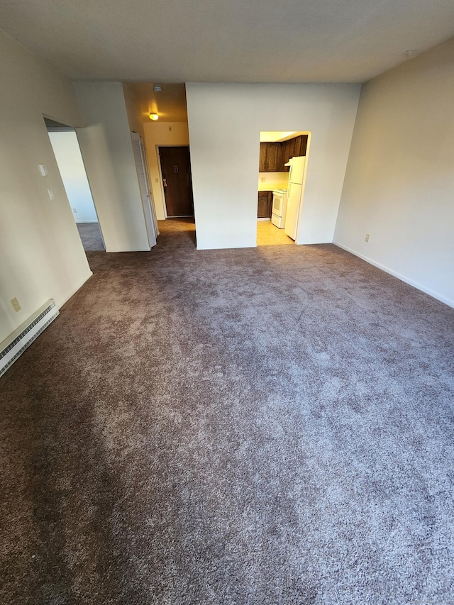 unfurnished living room with carpet and a baseboard heating unit