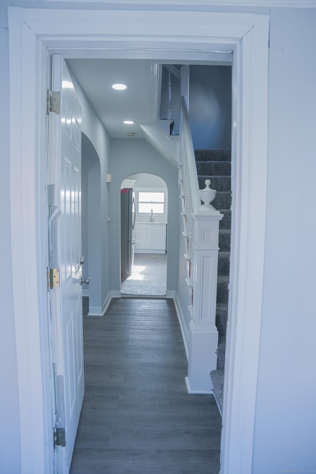 hallway with dark hardwood / wood-style floors and sink