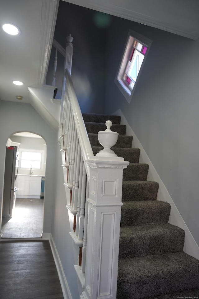 stairs featuring hardwood / wood-style floors