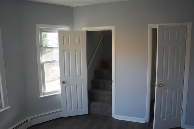 stairs with hardwood / wood-style flooring and baseboard heating