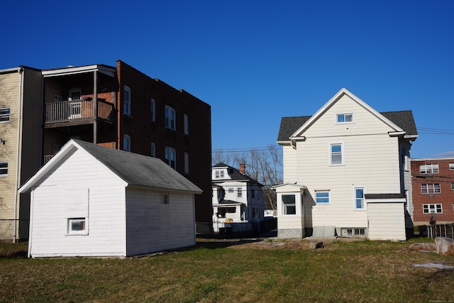 back of property featuring a yard