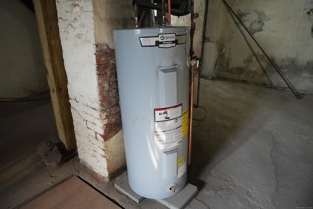 utility room featuring water heater