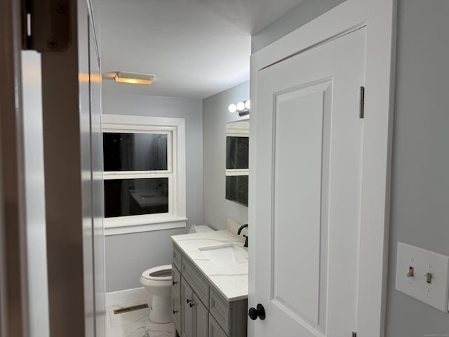 bathroom featuring toilet and vanity