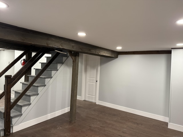 basement with dark hardwood / wood-style flooring