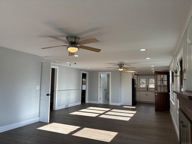 interior space with ceiling fan and dark hardwood / wood-style flooring