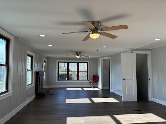 empty room featuring a brick fireplace, ornamental molding, and dark hardwood / wood-style flooring