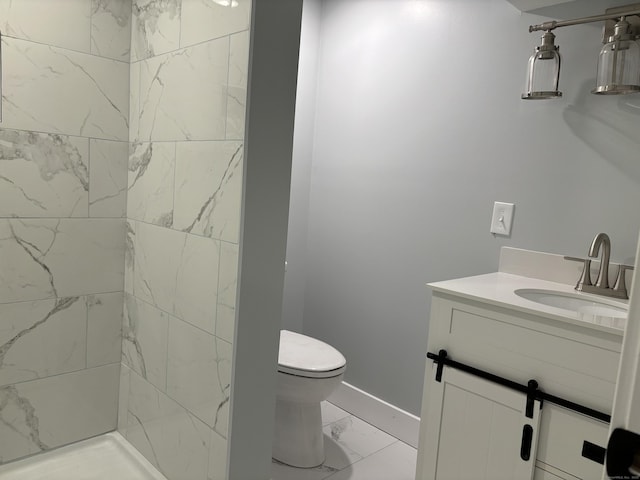 bathroom featuring tiled shower, toilet, and vanity