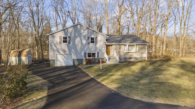 tri-level home with an attached garage, a storage shed, an outdoor structure, driveway, and a chimney