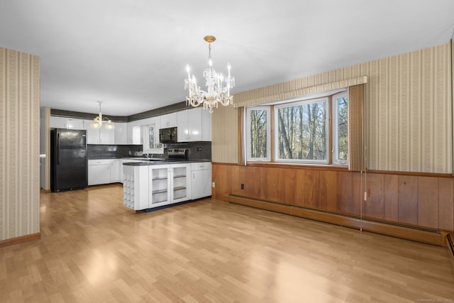 kitchen featuring a wainscoted wall, white cabinetry, black appliances, dark countertops, and wallpapered walls