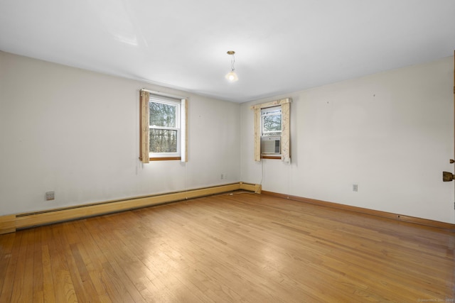 unfurnished room featuring light wood-style flooring, baseboards, and baseboard heating