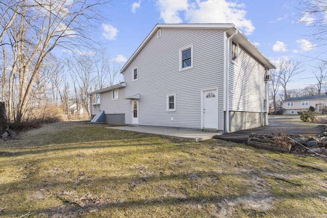 rear view of property featuring a patio area and a lawn