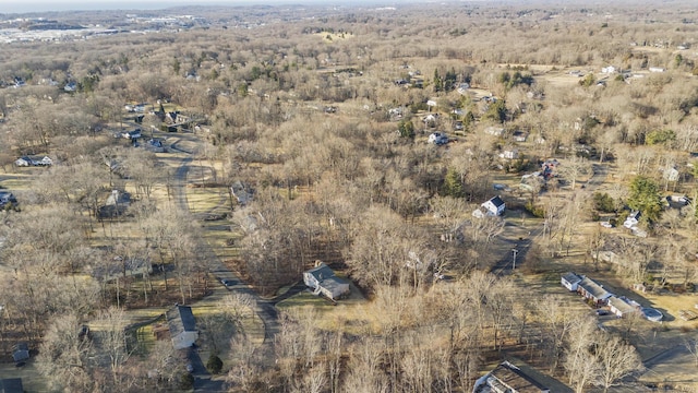 birds eye view of property featuring a forest view