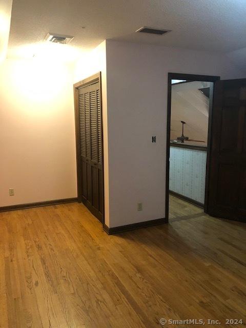 unfurnished room featuring hardwood / wood-style flooring and ceiling fan