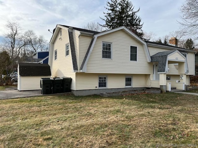 view of property exterior featuring a lawn