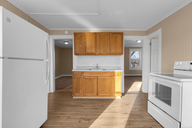 kitchen with white appliances, sink, decorative backsplash, light wood-type flooring, and baseboard heating