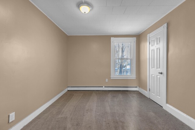 empty room with carpet floors, baseboard heating, and ornamental molding