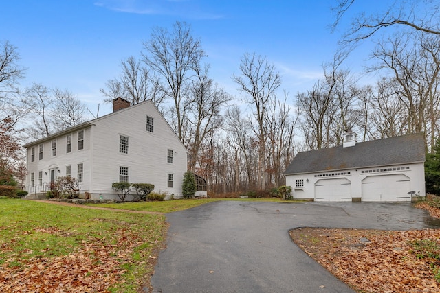 view of property exterior with a lawn and a garage