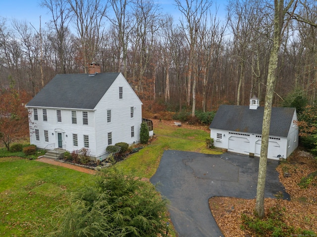 view of side of property with a lawn and a garage