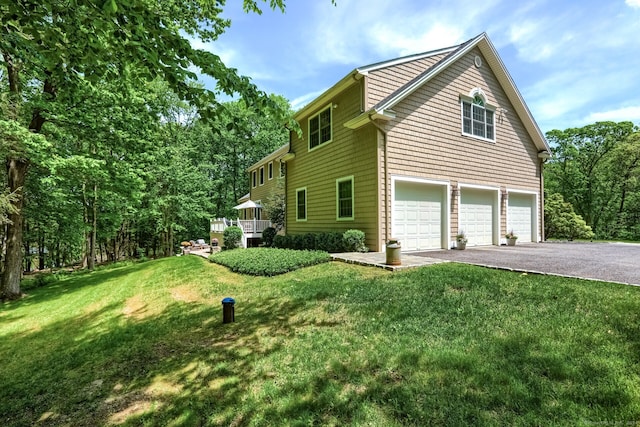 view of home's exterior with a yard and a garage