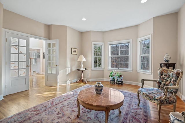 sitting room featuring french doors and light hardwood / wood-style flooring