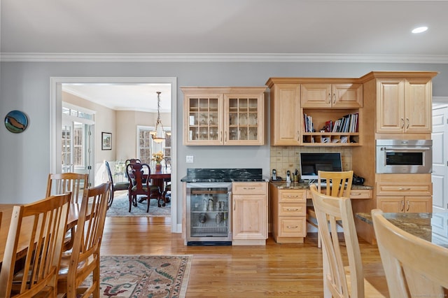 kitchen with wine cooler, light brown cabinetry, oven, and light hardwood / wood-style flooring