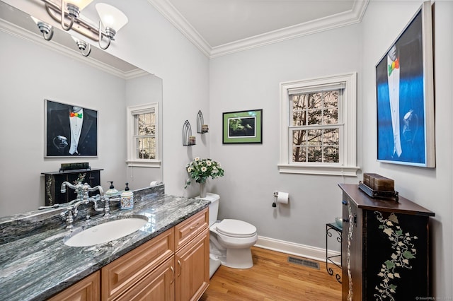 bathroom featuring hardwood / wood-style floors, vanity, ornamental molding, and toilet